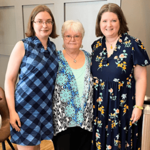 Group of three women smiling, representing Access Unleashed team members.
