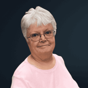 Accessible community advocate with a warm smile and glasses.