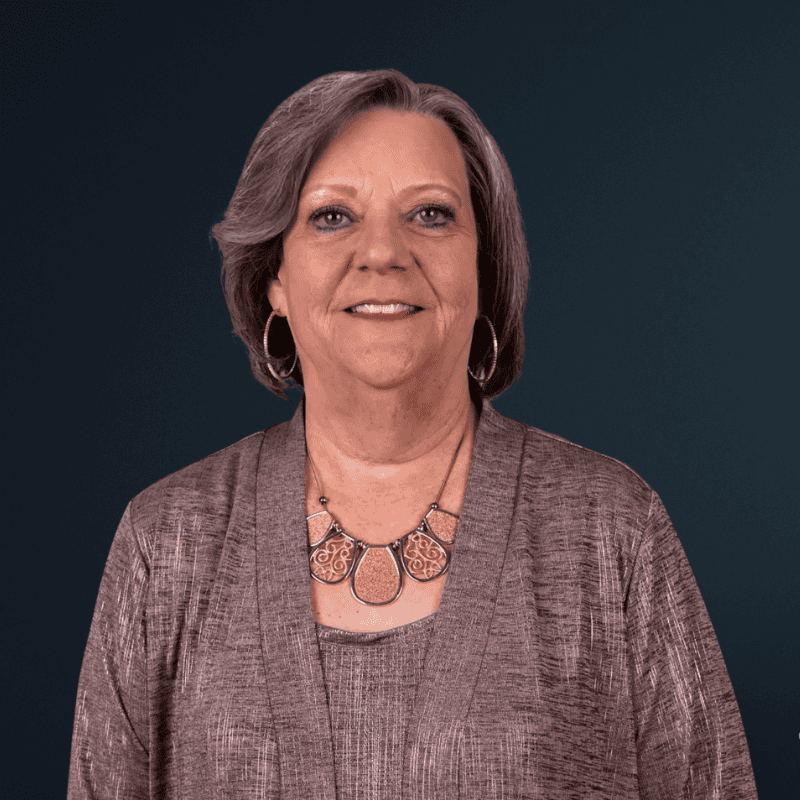 Accessible image of a woman smiling, representing community and inclusion.