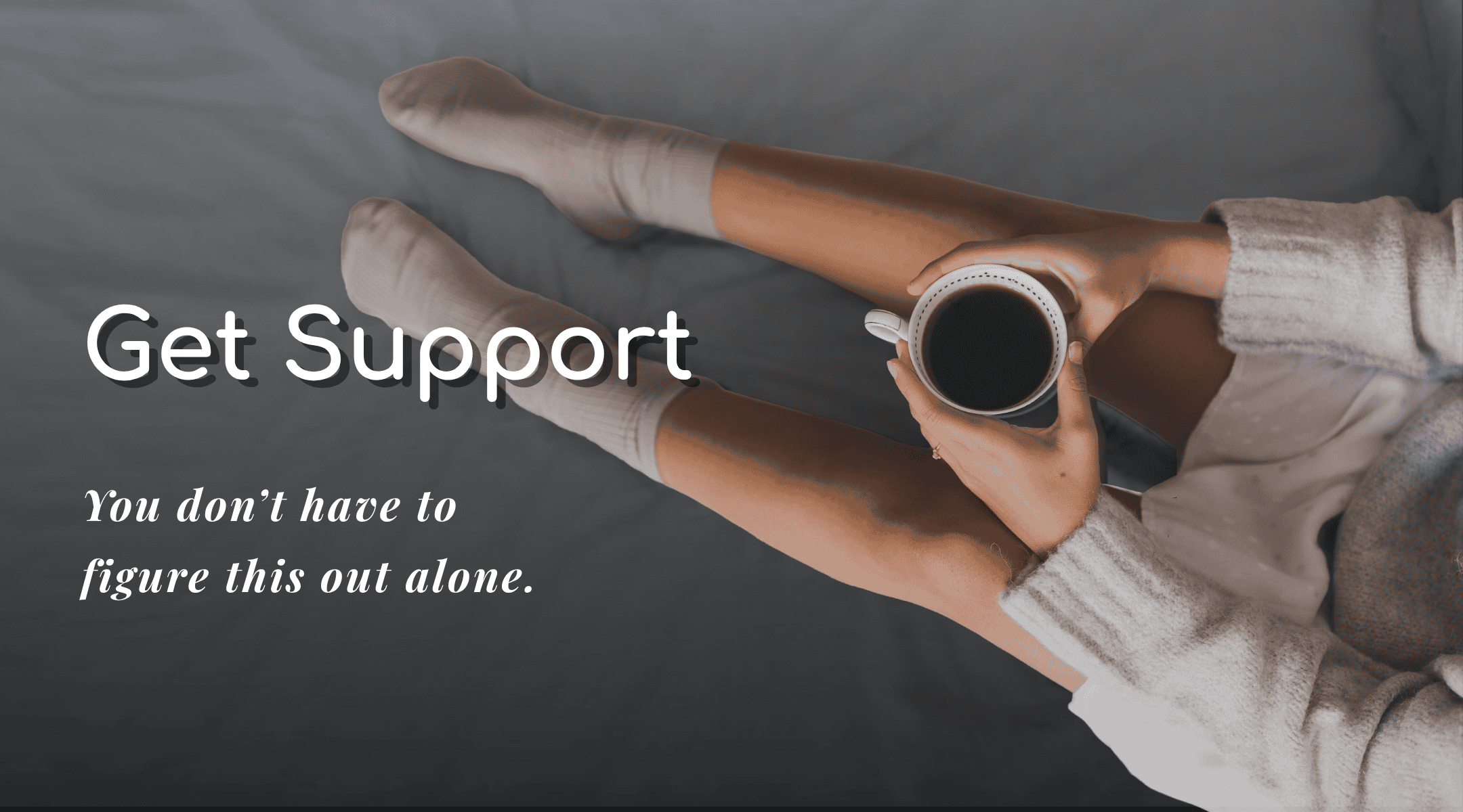 Person holding a coffee mug with legs stretched out, promoting support and comfort.