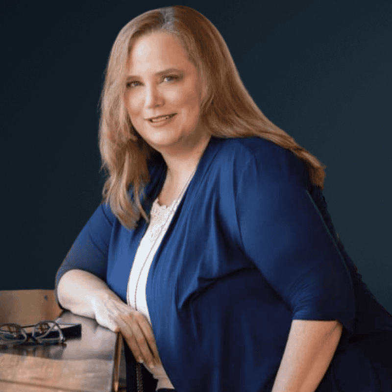 Empowered woman smiling at Access Unleashed, promoting accessibility and inclusion.